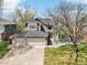 Lovely two-story home boasts a three-car garage and a well-maintained front yard with mature trees at 13071 Emerson St, Thornton, CO 80241