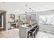 Bright kitchen features an island with granite countertops, stainless steel appliances, and wood plank flooring at 13071 Emerson St, Thornton, CO 80241