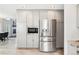 Kitchen with built-in stainless appliances, including a refrigerator, microwave, and plenty of cabinet storage at 13071 Emerson St, Thornton, CO 80241