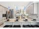 Kitchen island with stone countertop, seating, and stainless appliances is great for entertaining at 13071 Emerson St, Thornton, CO 80241