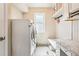 Bright laundry room featuring a new washer and dryer, storage and a convenient folding area at 13071 Emerson St, Thornton, CO 80241