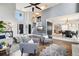 Bright, open-concept living area featuring a stylish staircase, a vaulted ceiling, and seamless flow to the dining area at 13071 Emerson St, Thornton, CO 80241