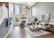 Inviting living room with a floor-to-ceiling brick fireplace, tall windows, and stylish decor at 13071 Emerson St, Thornton, CO 80241