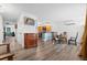 Open-concept dining area features wood flooring, modern light fixtures, and seamless flow into the adjacent kitchen at 7550 Stuart St, Westminster, CO 80030