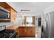 Functional kitchen featuring stainless steel appliances, breakfast bar, and wood countertops offering ample space at 7550 Stuart St, Westminster, CO 80030