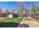 Spacious backyard with a detached garage, lawn, and wooden fence at 3527 W 44Th Ave, Denver, CO 80211