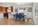 Bright dining room featuring a stylish table with blue upholstered chairs and wood floors at 3527 W 44Th Ave, Denver, CO 80211