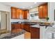 Charming kitchen with wood cabinets, granite countertops, and a breakfast bar at 3527 W 44Th Ave, Denver, CO 80211