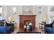 Bright living room featuring a decorative fireplace, neutral sofa, and blue accent chairs at 3527 W 44Th Ave, Denver, CO 80211