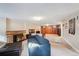 Finished basement featuring a sofa, a fireplace, and wood-paneled walls at 2630 Albion St, Denver, CO 80207