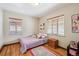 Bedroom with hardwood floors, natural light, and two windows at 2630 Albion St, Denver, CO 80207