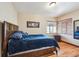 Bedroom with hardwood floors, a bed, and a window with blinds at 2630 Albion St, Denver, CO 80207