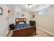 Cozy bedroom with a wooden frame bed, dresser, and natural light from windows at 2630 Albion St, Denver, CO 80207