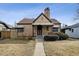 Charming brick home with a well-manicured front lawn and classic architectural details at 2630 Albion St, Denver, CO 80207