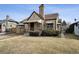 Quaint brick home with a landscaped front yard and charming covered porch at 2630 Albion St, Denver, CO 80207