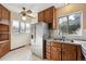 Eat-in kitchen with stainless steel refrigerator, granite countertops, and a ceiling fan at 2630 Albion St, Denver, CO 80207