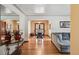 Bright living room featuring hardwood floors, archway to dining room, and neutral décor at 2630 Albion St, Denver, CO 80207