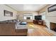 Cozy living room boasts a fireplace, hardwood floors, large sectional, and a bright yellow rug at 2630 Albion St, Denver, CO 80207