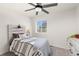 Inviting bedroom with a ceiling fan, accent wall, and natural light from a window at 28334 E 6Th Pl, Aurora, CO 80137