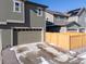 Attached two-car garage with a driveway and privacy fence on a sunny day at 28334 E 6Th Pl, Aurora, CO 80137