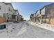 Street view of townhomes on a snowy day showing the exterior architecture and front yards of homes in the community at 28334 E 6Th Pl, Aurora, CO 80137