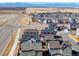 Aerial view of a housing development and the Rocky Mountains in the distance at 28334 E 6Th Pl, Watkins, CO 80137