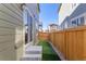 Small fenced backyard with a patch of artificial grass at 28334 E 6Th Pl, Watkins, CO 80137