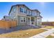 Charming two-story home features a welcoming front porch and a well-manicured lawn at 28334 E 6Th Pl, Watkins, CO 80137