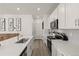 Bright and airy kitchen with white cabinetry, stainless steel appliances, and a functional island with seating at 28334 E 6Th Pl, Watkins, CO 80137