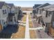 Street view of row of houses and common green space at 28334 E 6Th Pl, Watkins, CO 80137