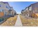 Street view of newer homes with xeriscaping and grass at 28334 E 6Th Pl, Watkins, CO 80137