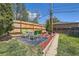 Backyard patio with a table, chairs, and decorative landscaping surrounded by a wood fence at 6436 Otis St, Arvada, CO 80003