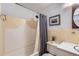 The bathroom includes a shower over tub, picture, and a modern vanity with sink at 6436 Otis St, Arvada, CO 80003