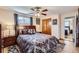 This is a cozy bedroom with a queen bed, windows, wood floors, and small closet at 6436 Otis St, Arvada, CO 80003