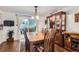 Dining area with wooden table, china cabinet and large sliding glass door to patio at 6436 Otis St, Arvada, CO 80003