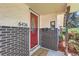 Inviting front entry featuring a red door, brick accents, and clear address numbers at 6436 Otis St, Arvada, CO 80003