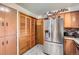 Kitchen area shows stainless steel refrigerator and oak cabinets at 6436 Otis St, Arvada, CO 80003