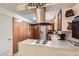 Functional kitchen featuring a sleek range hood, efficient layout and ample storage at 6436 Otis St, Arvada, CO 80003