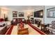 Comfortable living room featuring a fireplace, leather furniture, and decorative artwork at 6436 Otis St, Arvada, CO 80003
