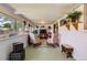 Inviting sun room with large windows, comfortable seating, and decorative plants at 6436 Otis St, Arvada, CO 80003