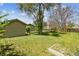 Spacious backyard with lush lawn and mature trees, perfect for outdoor activities at 180 S Lamar St, Lakewood, CO 80226