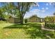 Spacious backyard with lush green lawn and shade from mature trees, showing the home exterior at 180 S Lamar St, Lakewood, CO 80226