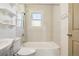 Bathroom featuring tile walls, bathtub with shower, and built-in shelves at 180 S Lamar St, Lakewood, CO 80226