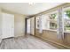 Bright bedroom featuring neutral paint, wood-look flooring, and large windows with decorative curtains at 180 S Lamar St, Lakewood, CO 80226