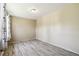 Neutral bedroom featuring wood-look flooring, neutral walls, and a decorative curtain at 180 S Lamar St, Lakewood, CO 80226