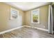 Bedroom with wood-look flooring and dual windows providing natural light at 180 S Lamar St, Lakewood, CO 80226