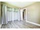 Bedroom with wood-look flooring, open closet with curtains, and ample space at 180 S Lamar St, Lakewood, CO 80226