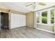 Bedroom featuring natural light, a closet, and wood-look flooring, with convenient access to the bathroom at 180 S Lamar St, Lakewood, CO 80226