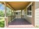 Covered front porch with wood flooring and lattice railing, offering a welcoming outdoor space at 180 S Lamar St, Lakewood, CO 80226