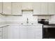 Bright kitchen featuring white cabinets, granite countertops, stainless steel appliances, and a sleek faucet at 180 S Lamar St, Lakewood, CO 80226